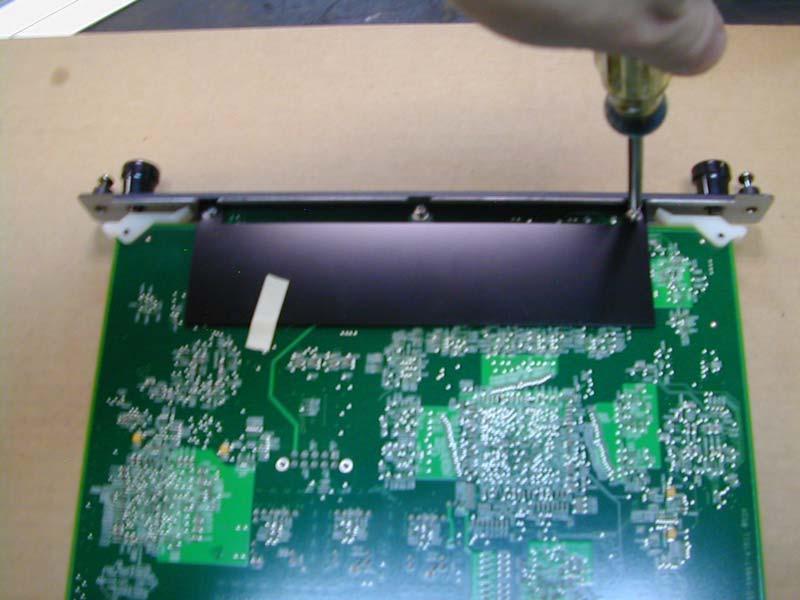 13. Once the face plate has been secured to the board insert the board back into the proper slot of the projector.
