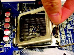 Step 3: Lift the metal load plate on the CPU  Step 4: Hold the CPU with your