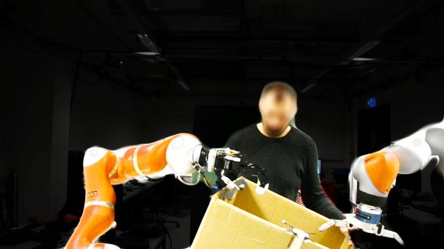 4. In this second scenario, a blindfolded operator holds the box while walking towards the robots.