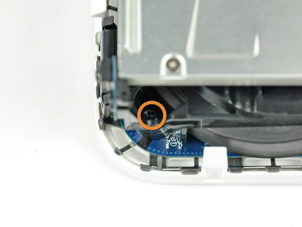 Remove the recessed Phillips screw near the power button securing the internal frame to the bottom