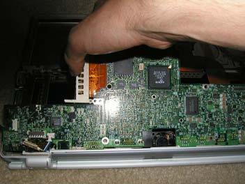 Grasp the logic board as shown and gently pull up.
