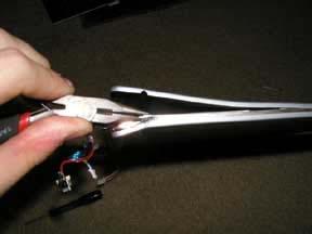 Use a pair of needle nose pliers to extract the hinge when it is loose enough to be pulled out.