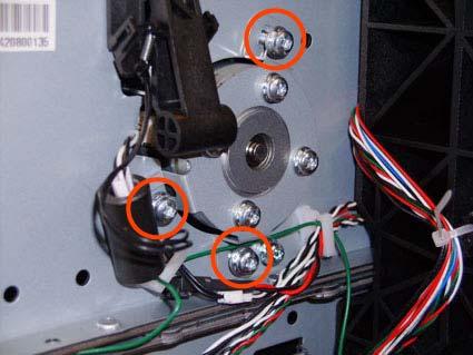 Remove three T-20 screws that secure the