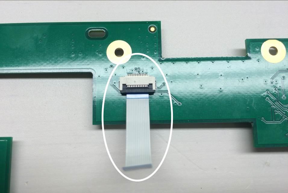 Insert the small touch ribbon cable to the NEW PCB as shown (contacts