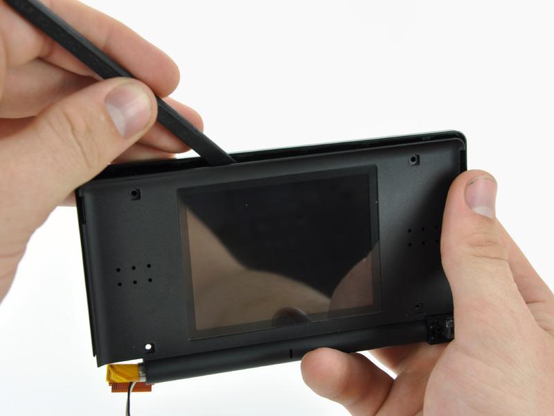 Step 25 Insert a spudger in the gap between the front and rear display bezels and pry the