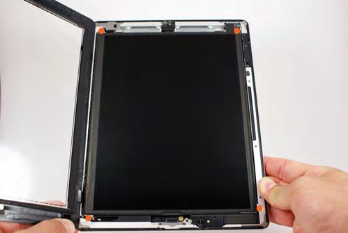 Locate and remove the four small Phillips screws (#00) that secure the LCD screen to
