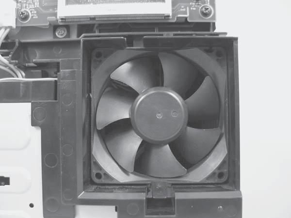 3. Release three tabs (callout ), and then remove the fan. NOTE: As the fan is removed, you must feed the wire harness through an opening behind the fan duct.