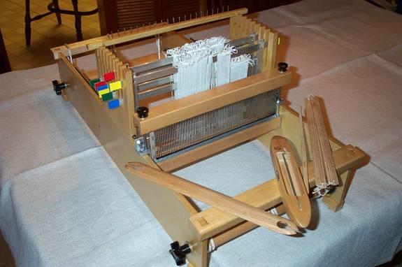 I mount my ipad on the castle of my Jane table loom. Reaching up to tap on Next uses the same movement as I use to change the shafts and does not slow me down at all.