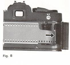 Draw the film leader across the camera back and insert it into one of the slits of Film Take-up Spool (35) (Fig. 8).