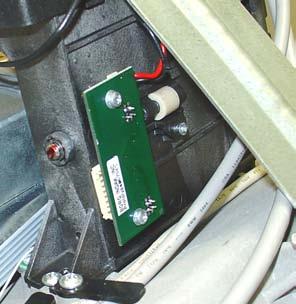 Using a phillips screwdriver, remove the two (2) screws that secure the presenter board. Retain the screws.