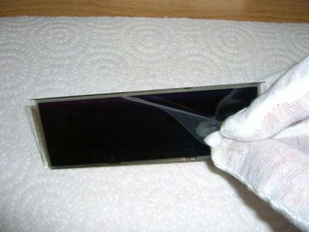 The LCD is protected from scratches/fingerprints by protective films on each side.