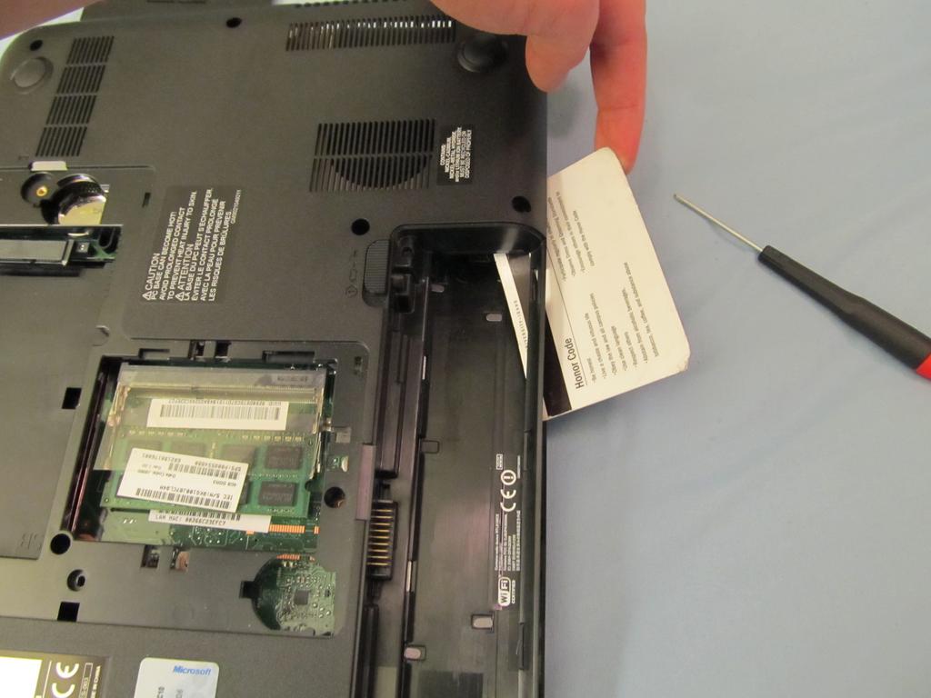 Step 8 Slide a credit card all the way around the outer edge of the laptop to help pry the plastic clips