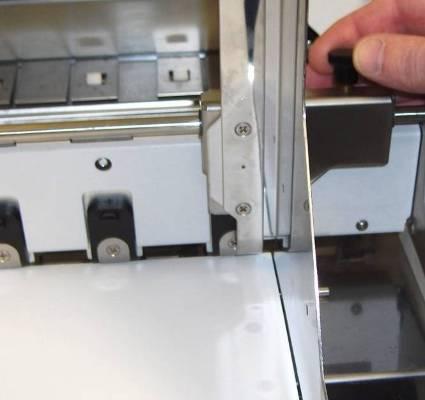 SECTION 3 OPERATING THE PRINTER 3. Loosen the locking screws, located behind the sheet separators, and raise the separators.
