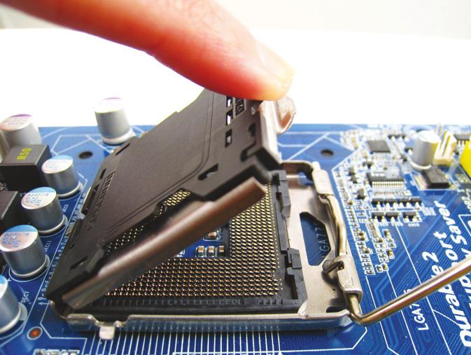 Step 2: Lift the metal load plate from the CPU socket. (DO NOT touch socket contacts.