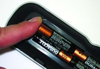 Observe the + and - polarity indications inside the battery compartment.