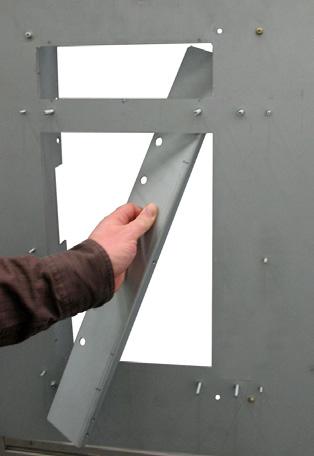 Locate the reinforcement plate on the mounting panel.