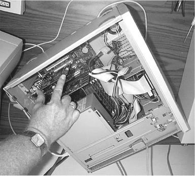 Inserting the IEEE1394 Board into the PC. 4. Secure the board to the PC by fastening the board to the back of the case.