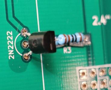 Gently push the transistor toward the PCB but don't press it hard to the board as you risk damaging