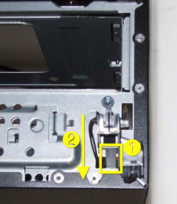 9. Press the tab (1) on the bottom of the power switch to disengage it from the chassis, slide the switch downward to disengage the tabs from the chassis (2), and then pull the power switch