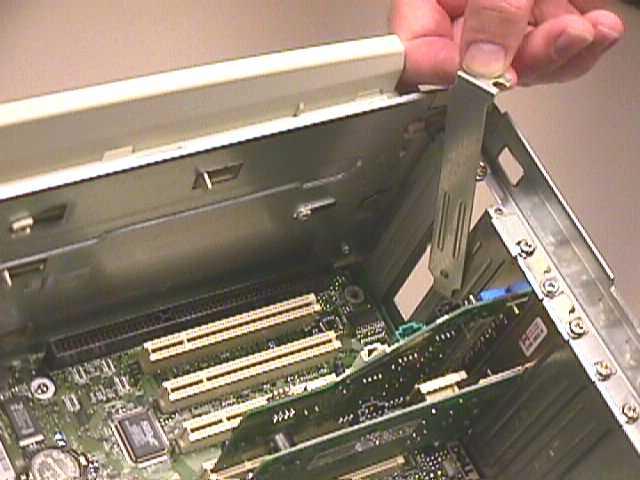 5-6 Remove the metal PCI slot cover from the unused PCI slot, and retain the screw. PCI Slot Remove PCI slot cover 5-7 Carefully insert the Ethernet Adapter into any empty PCI slot.