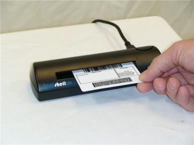 If you are installing the Scanshell scanner (shown at left), insert your driver license into the scanner facedown with the top of the driver license inserted first.