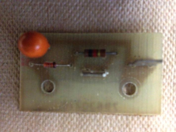 Figure 3. Circuit board with resistor, diode, and capacitor mounted and soldered in place. Two vertical spade lugs simplified connection to the transformer and reed switch.
