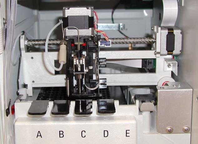 The XYZ arm moves to the center front of the tray compartment and the needle holder moves down 1 inch (see Figure 218). Figure 218. XYZ arm in the needle removal position (Accela Autosampler) 2.