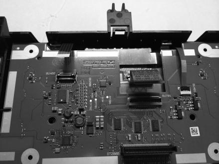 Release the LCD ribbon cable by lifting the black clip on