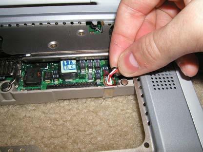 Remove the backup battery cable as shown by gently