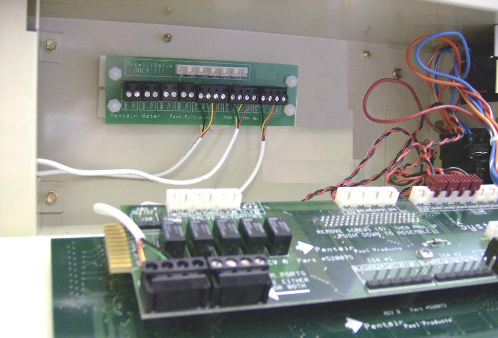 connectors (with the attached wires to equipment) from the Personality board and plug it into an available connector on the Expansion board COM port (as shown below).