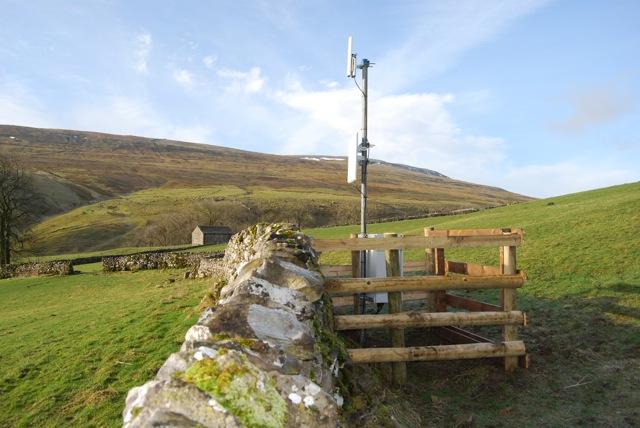 village. The masts contain a small transceiver dish that receives the signal and a small ariel - a secondary relay - to relay the signal around the area.
