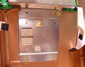 9600 6. Install the keypad retaining plate with the 4 (four) short standoffs.