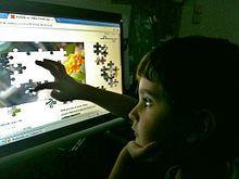 Fig3: A child solves a computerized puzzle using a touchscreen. A touch screen is an electronic visual display that can detect the presence and location of a touch within the display area.