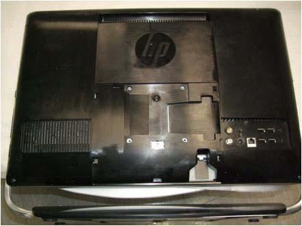 7. Place the back cover on the computer and install the three screws that secure the back cover to