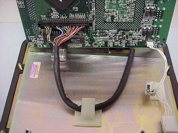 6. Gently tilt the circuit board up along the fan edge of the board and remove the video cable, inverter cable and touchscreen cable. See Figure 17. The CPU circuit board is now free from the unit.