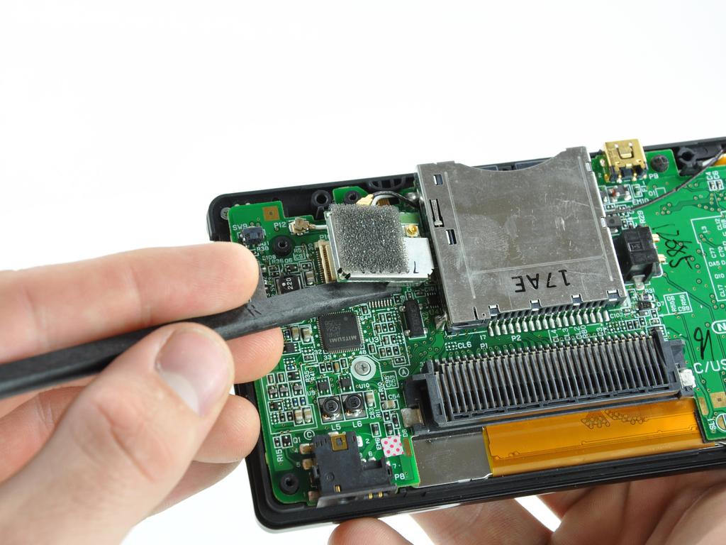 Repairing a Nintendo DS that is not charging Step 10 Use the flat edge of a spudger to separate the right edge
