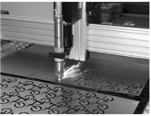 Task 5 A laser cutting machine is used to cut sheet steel, as shown in the photograph below. The laser is positioned by motors A and B which are operated by a microcontroller.
