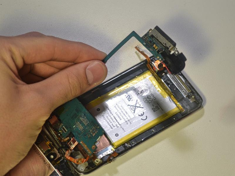 Once heated, gently pry the logic board up with a cell phone opening tool.