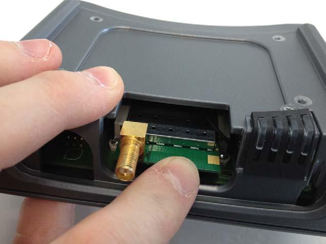 Slide it in until it clicks into place. Figure 14: Slide the Wi-Fi X-Card into slot until it clicks in place.