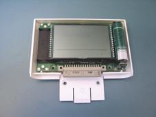 Lay the Display Module on a flat surface, with the display facing upwards, and carefully remove the upper part of the plastic cover.