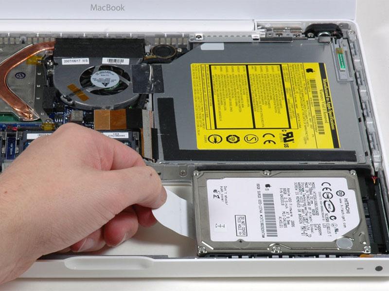 Step 13 Optical Drive Grasp the white plastic tab attached to the hard drive and