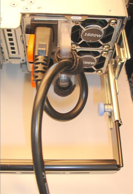 1.3. Routing the power cables through the strain reliefs After you have installed the SRB and cables, route the power cables through the strain reliefs located on the power supply handles as shown in