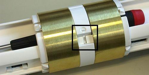 To advance the sensor assembly to its location on the rail, press and hold the spot indicated by the