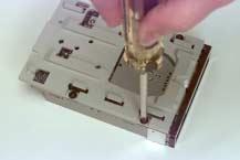 Remove floppy disk EMI shield Remove the hard drive carrier tray by removing the four screws and