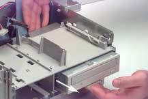 Remove hard drive cables Lift the tab at the front of the CD-ROM drive and push it forward.