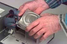 remove the SCSI and power cables and remove the drive from the machine.