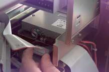 Adjust the fit of the floppy drive by pushing the rear of the drive toward the front of