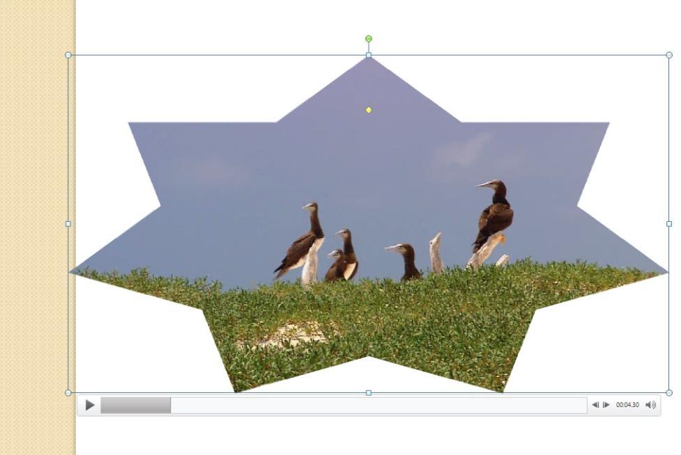 Crop Your Video to Play in a Shape by selecting the Video Shape command in the Ribbon.