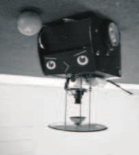Figure 1.4: The Classic -Robot using omnidirectional vision. A small camera is directed upwards looking into a parabolic mirror that reflects the 360 degree of field around the robot.
