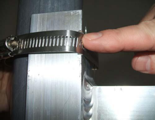 Tighten the steel fastener strap with a flat head screwdriver as shown.